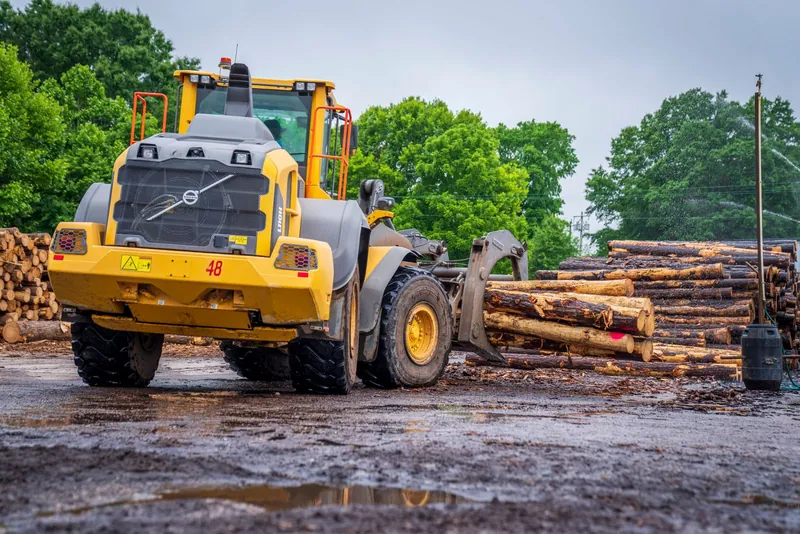Ga Be Tree Service loader clearing logs during a lot-clearing job